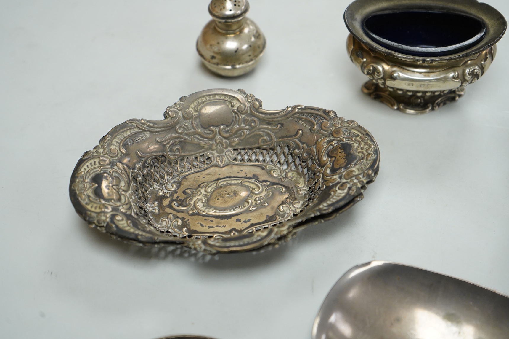 A collection of small silver, including a George III cream jug, London, 1762, 88mm, a George V sugar caster, small five bar toastrack, pair of bonbon dishes, pepperette, dish, two condiment spoons and mustard pot, togeth